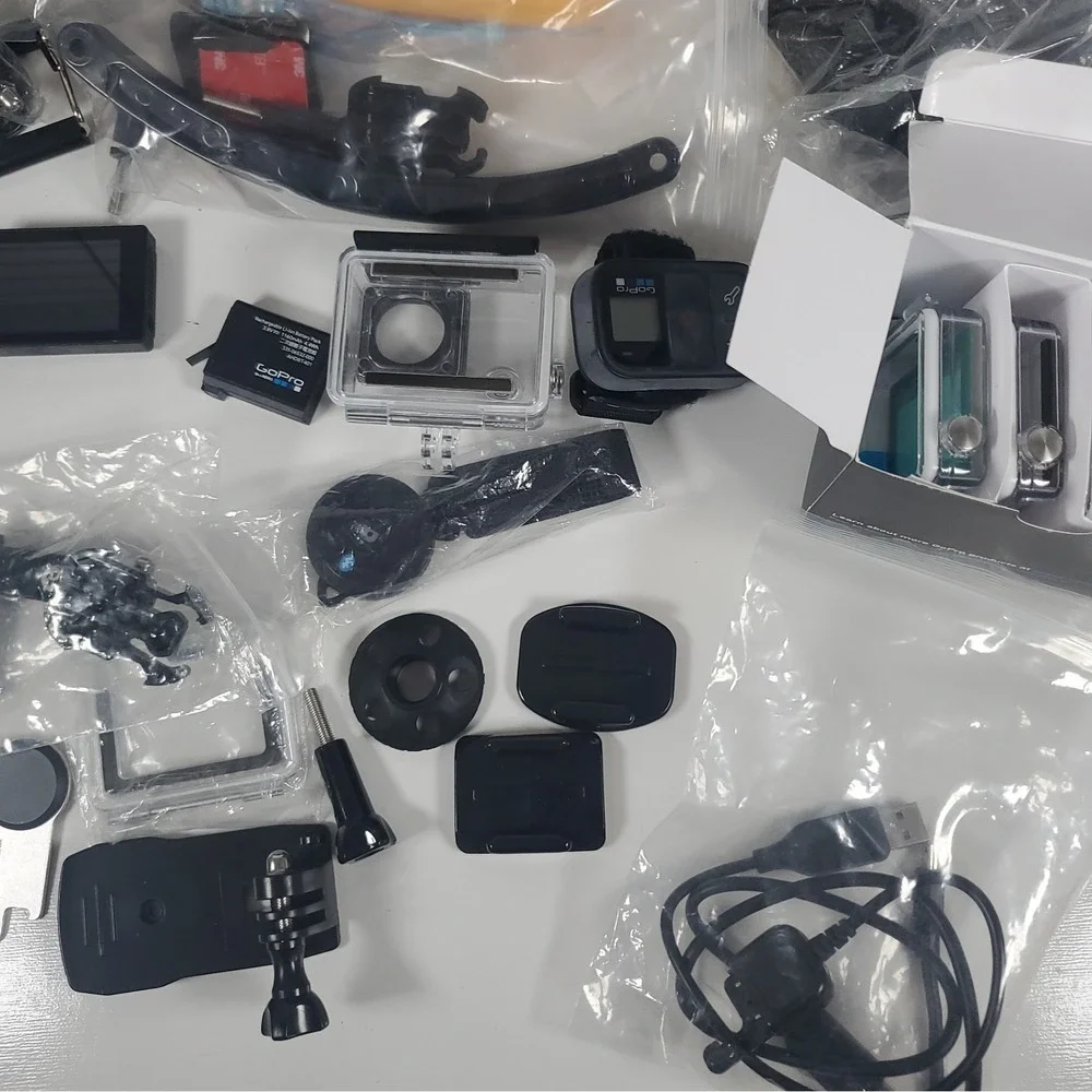 GoPro Hero4, Two Batteries, And Accessories Lot. Mounts, Body And Head Harness
